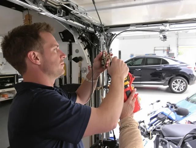 Pataskala Garage Door Repair safety certified technician performing cable replacement in Pataskala